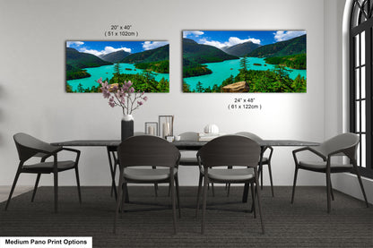 a dining room with a large, framed landscape painting hanging on the wall above a wooden dining table surrounded by chairs.