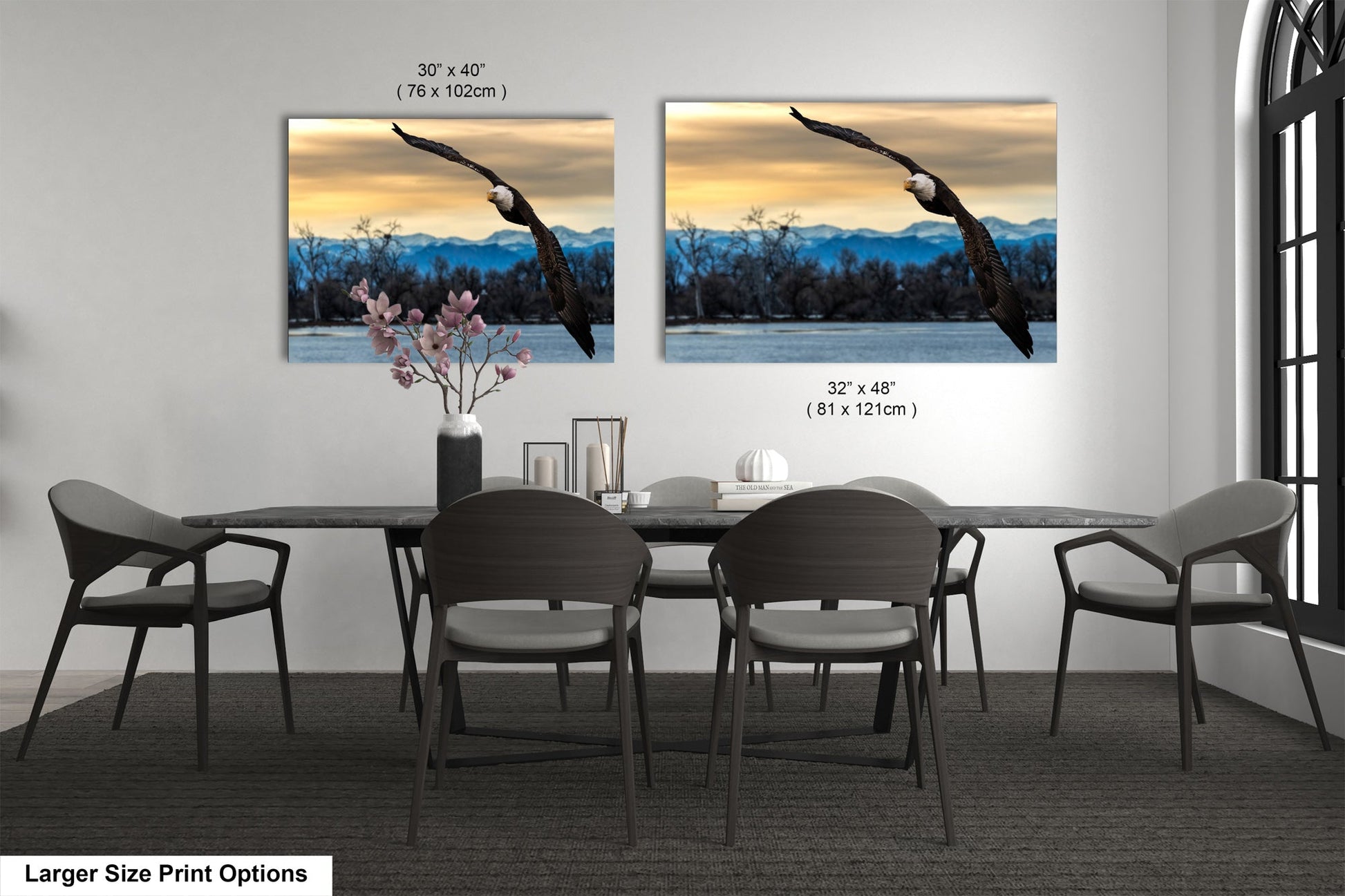 a dining room table with four chairs and a vase of flowers