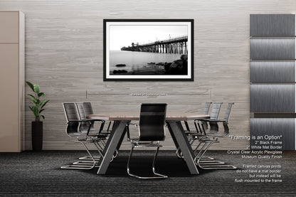 a black and white photo of a table and chairs