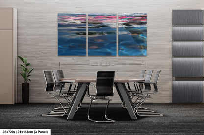 a dining room table with chairs and a painting on the wall