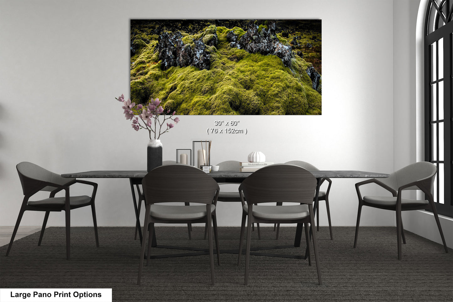 a dining room table with chairs and a painting on the wall