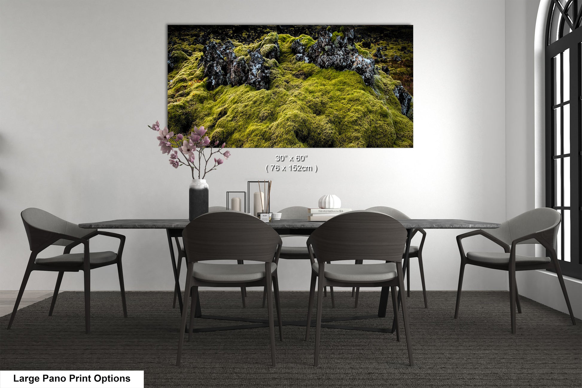 a dining room table with chairs and a painting on the wall