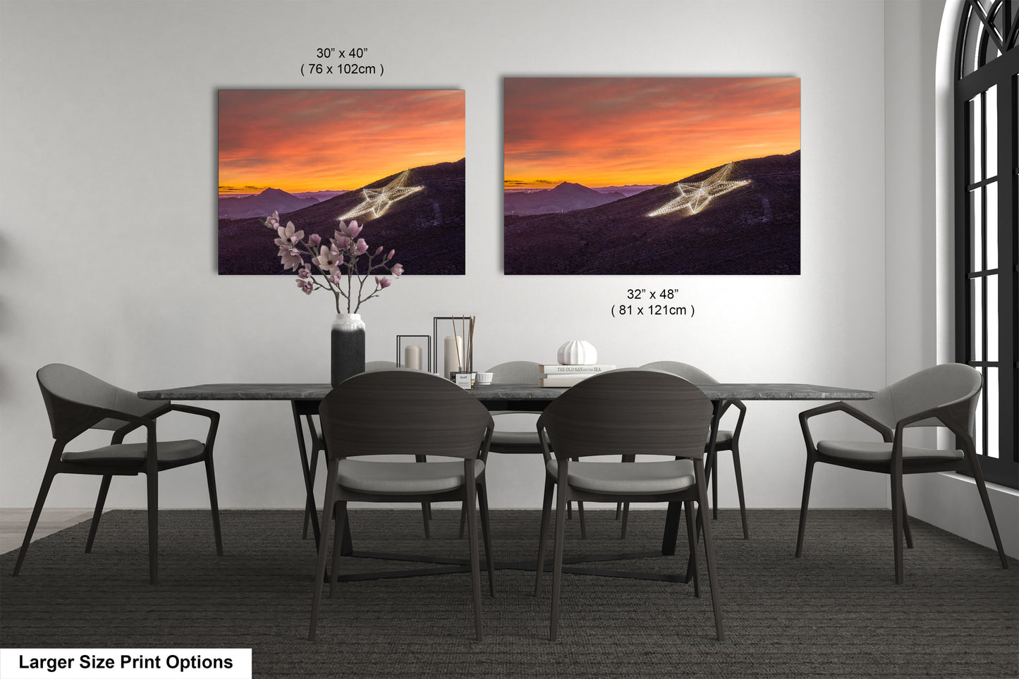 a dining room table with four chairs and a vase of flowers