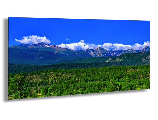 a scenic view of a mountain range with trees in the foreground