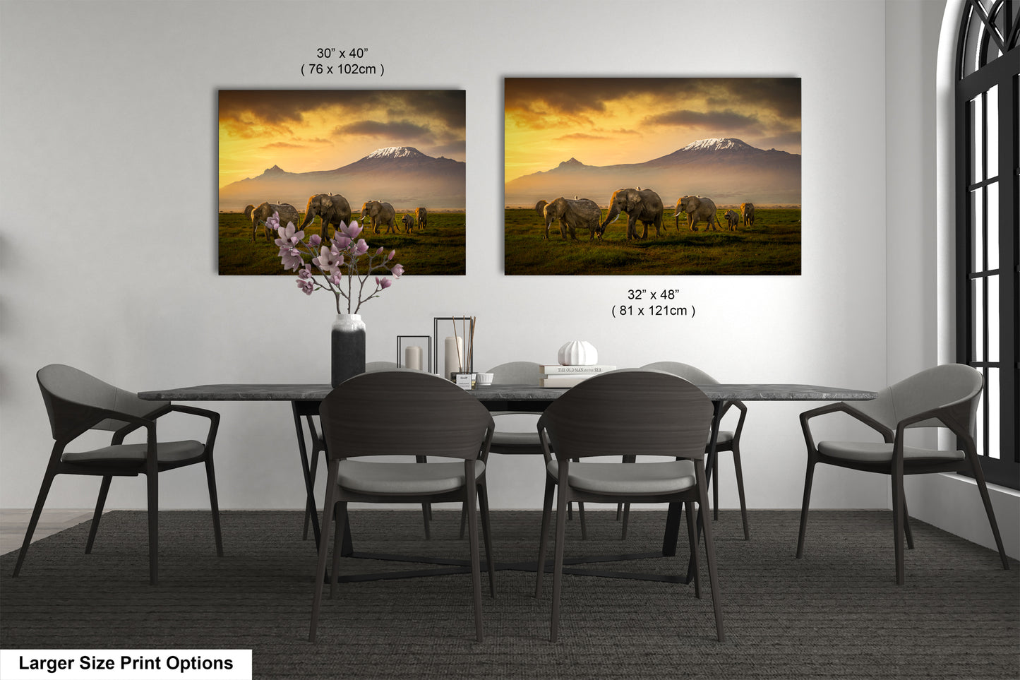 a dining room table with four chairs and a vase of flowers