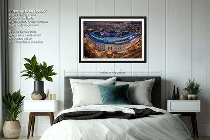 a bedroom with a large bed and a picture on the wall