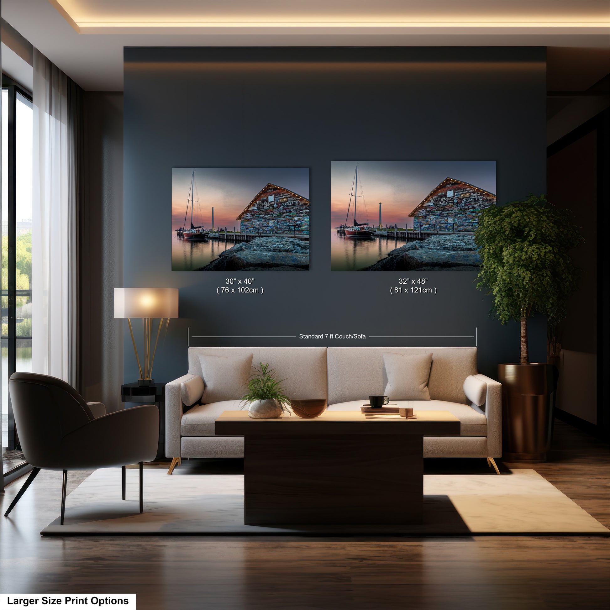 The image is a modern living room with a large sofa, a coffee table, and a lamp. There are two framed pictures of a building and a boat on the wall, and the text indicates the sizes of the pictures.