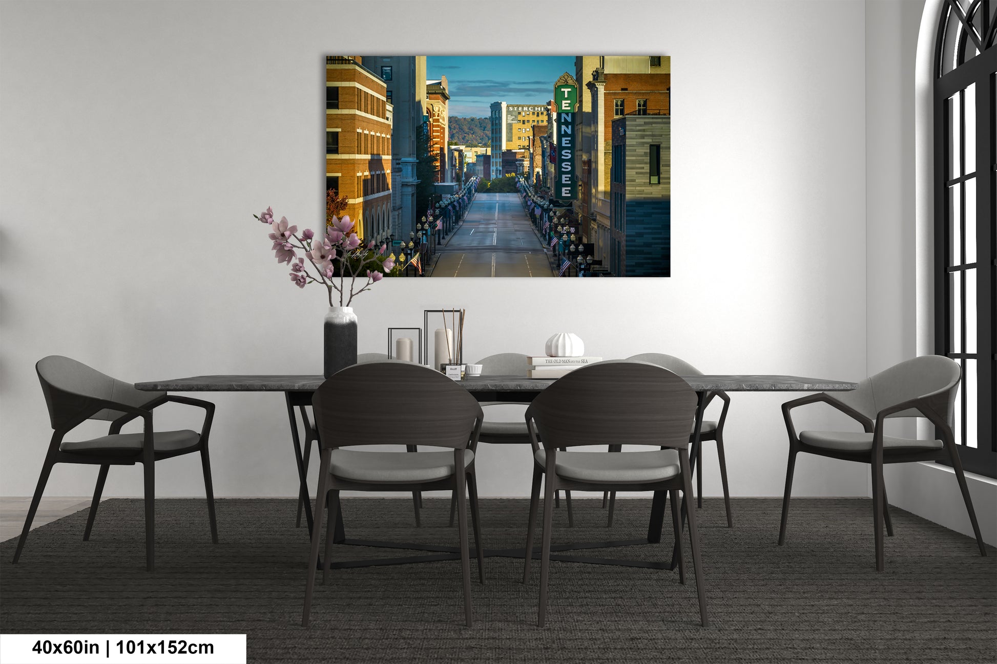 a room with a table and chairs and a painting on the wall