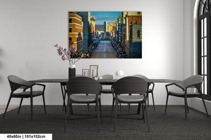a room with a table and chairs and a painting on the wall