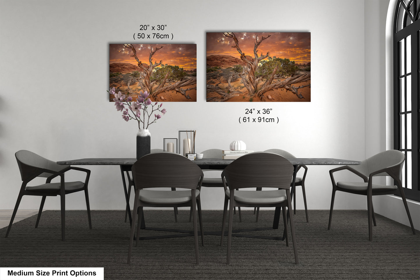 a dining room table with four chairs and a vase with flowers