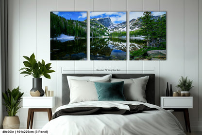 a bedroom scene with a bed and two paintings on the wall