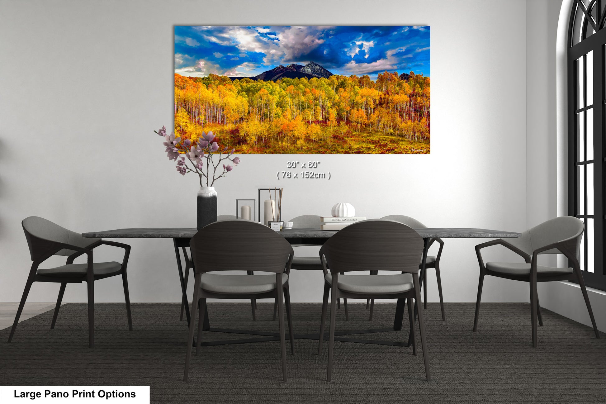 a dining room table with chairs and a painting on the wall