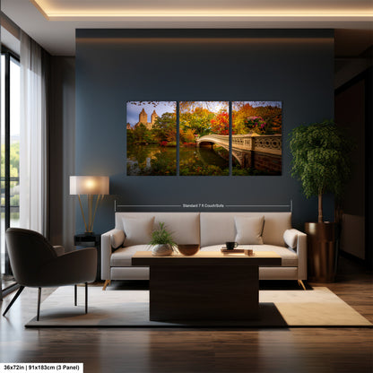 A modern living room with a large wall-mounted painting depicting a scenic view of Central Park in New York City. The painting features a bridge and trees in autumn colors, creating a serene and picturesque atmosphere. The room is furnished with a sofa, armchair, and coffee table, and is illuminated by a lamp and natural light from a window.