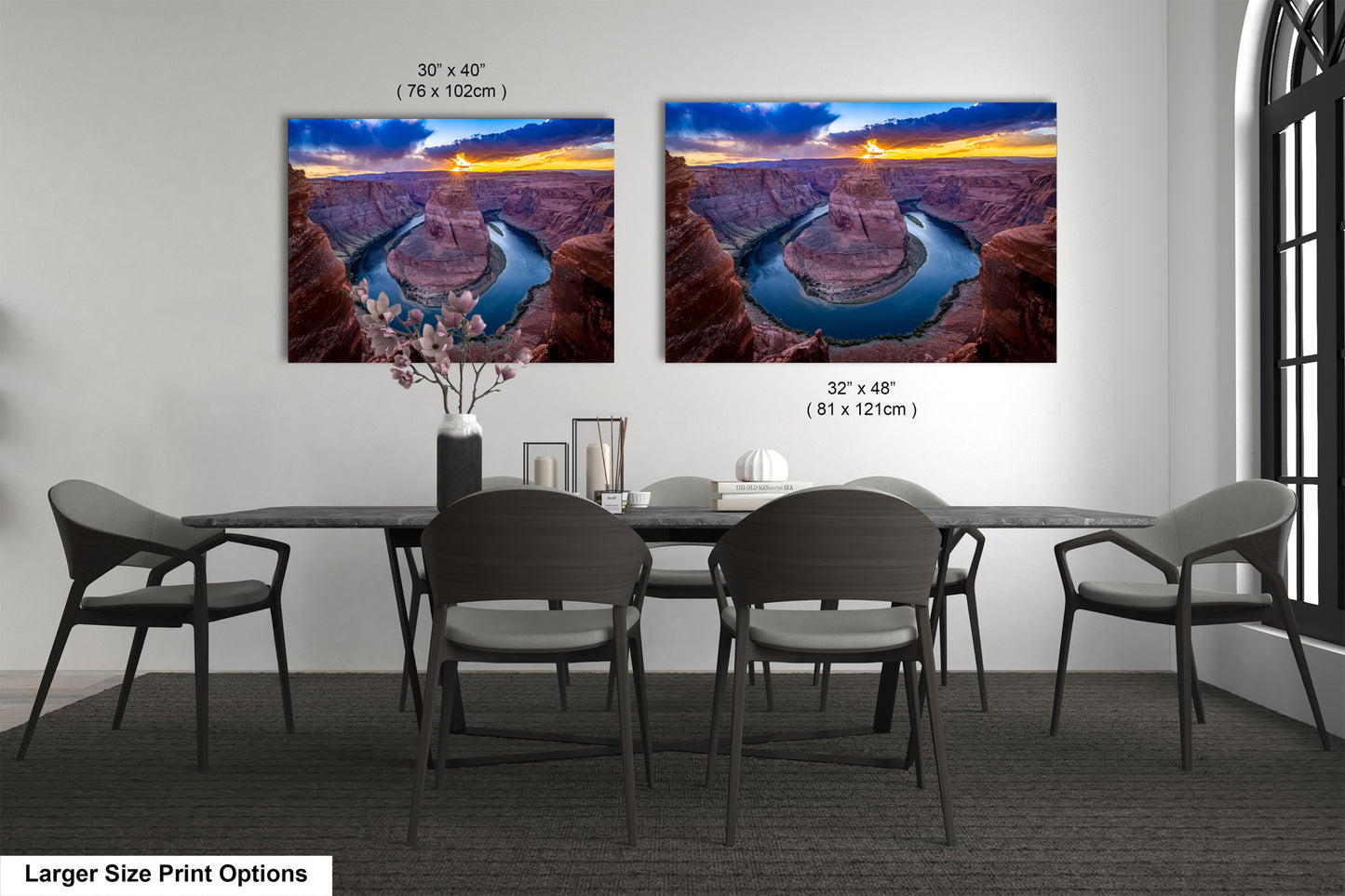 a dining room table with four chairs and two pictures on the wall
