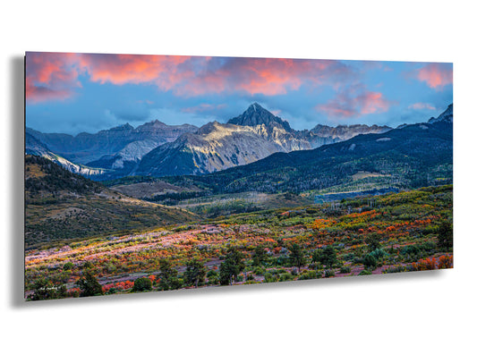 a scenic view of a mountain range at sunset