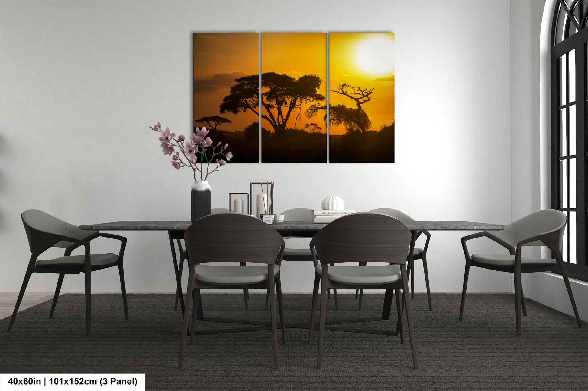 a dining room table with four chairs and a painting on the wall
