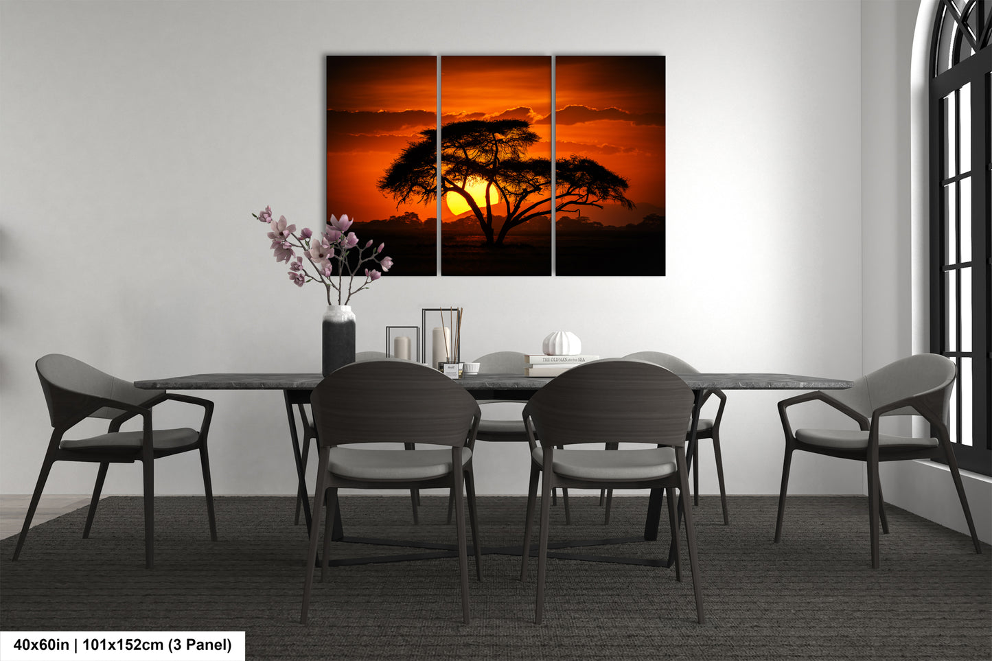 a dining room table with chairs and a painting on the wall