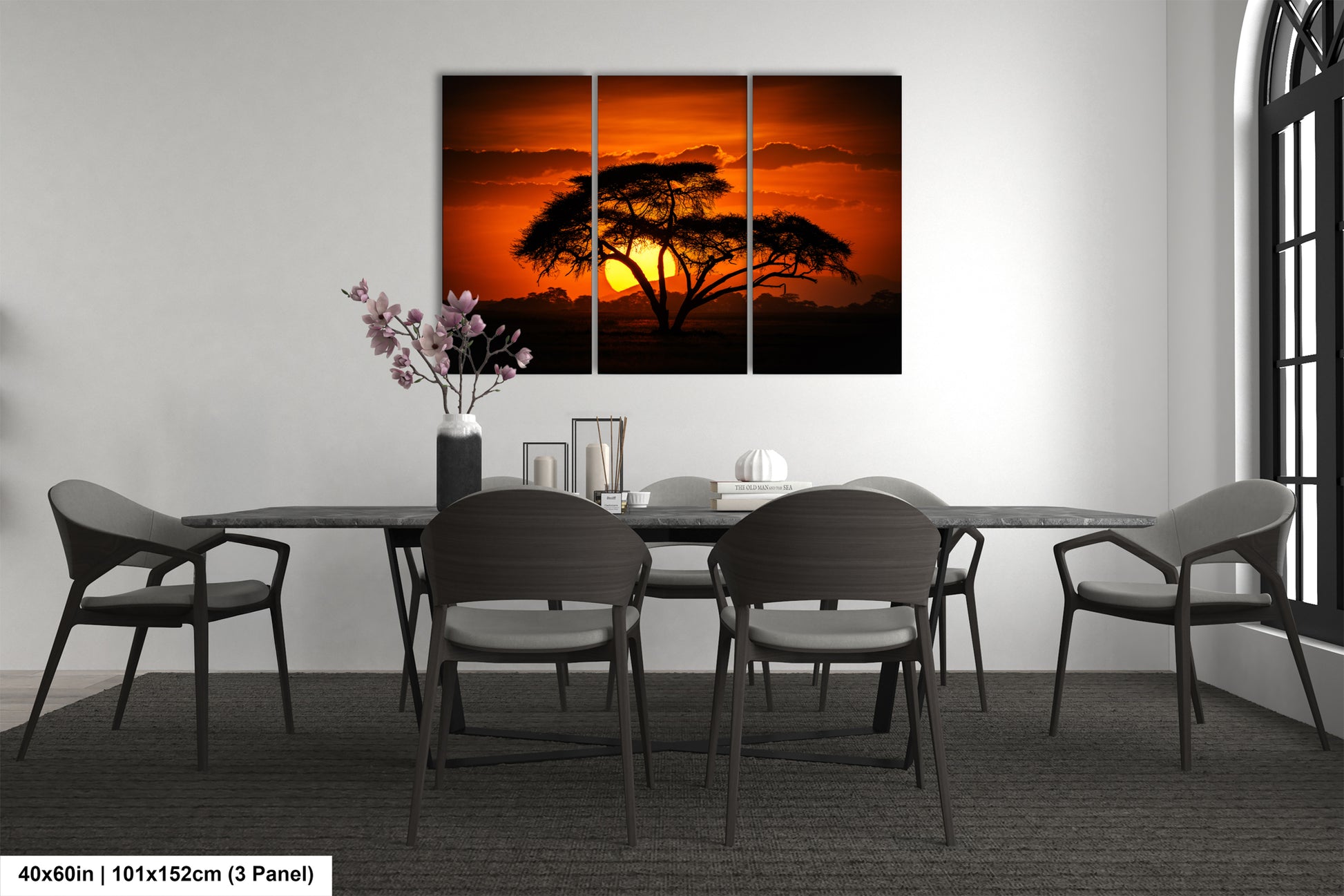 a dining room table with chairs and a painting on the wall