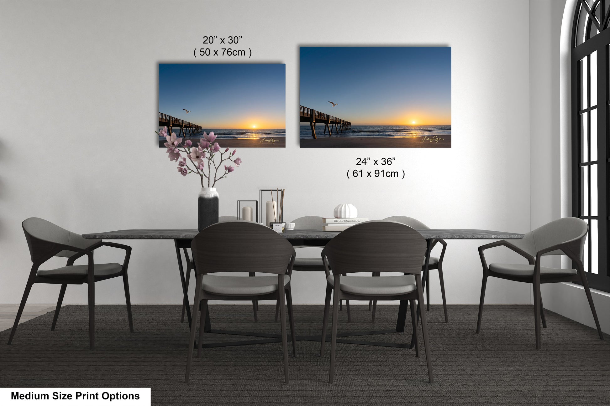 a dining table with four chairs and a vase of flowers