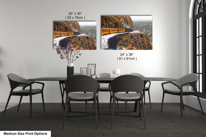 a dining room table with chairs and a picture of a road