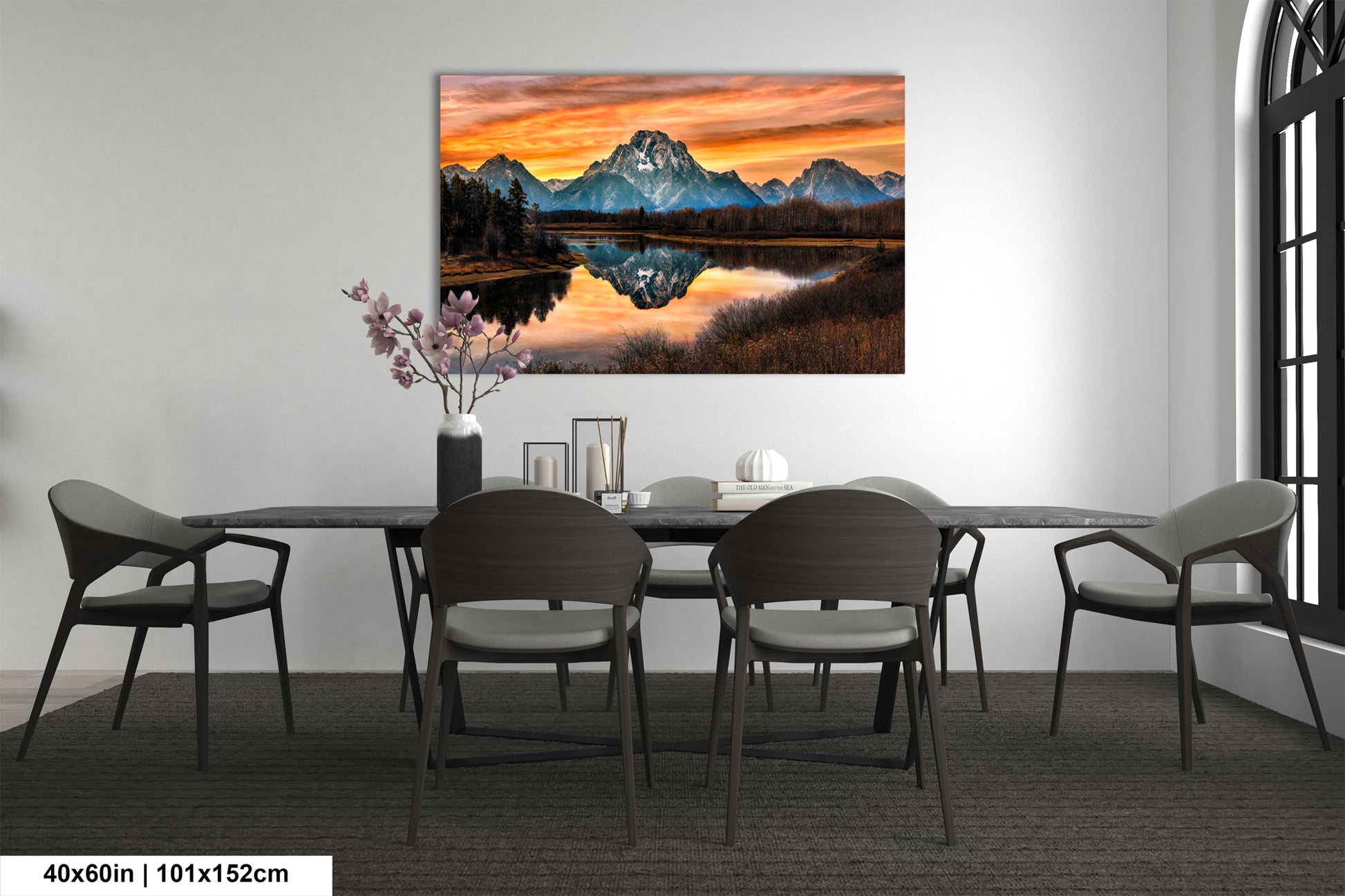 a dining room table with chairs and a painting on the wall