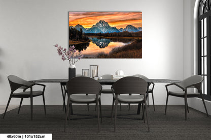 a dining room table with chairs and a painting on the wall