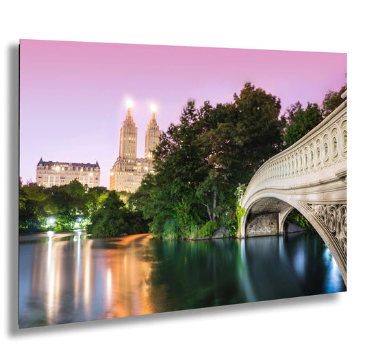 a bridge over a river with a city in the background