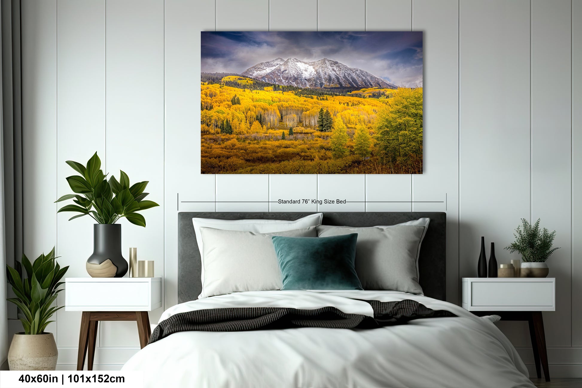 a bed room with a neatly made bed and a painting on the wall
