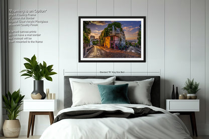 a bedroom with a bed and a picture hanging on the wall