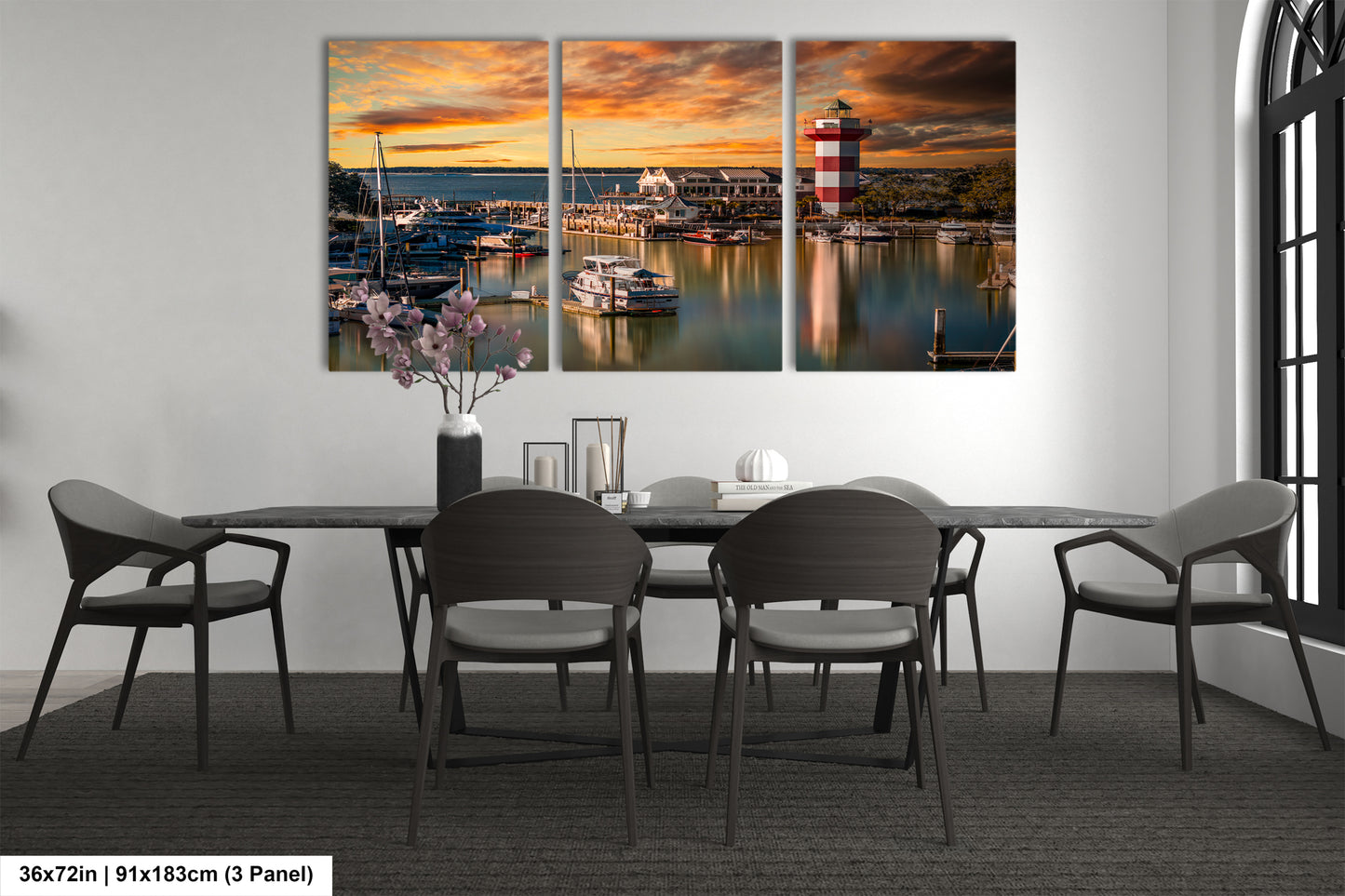 a dining room table with chairs and a painting on the wall