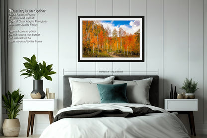 a bedroom with a bed and a picture hanging on the wall