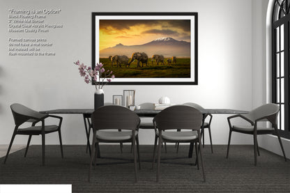 a dining room table with chairs and a painting on the wall