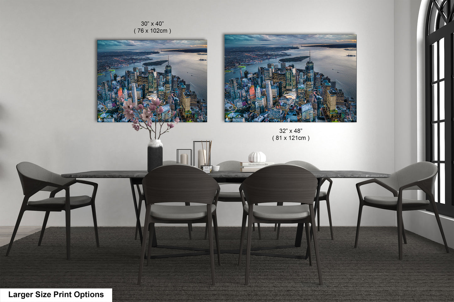 a dining room table with chairs and a painting on the wall