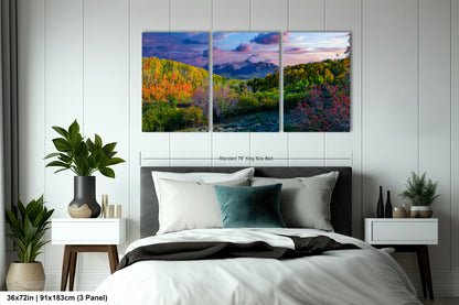 a bedroom with a bed and two paintings on the wall