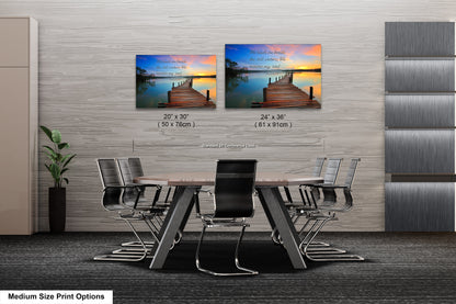 a dining room table with chairs and two pictures on the wall