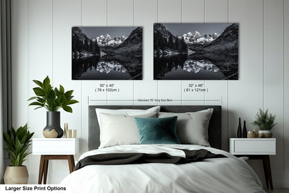 a bedroom with a bed and two pictures on the wall