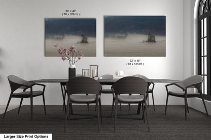 a dining table with four chairs and a vase of flowers