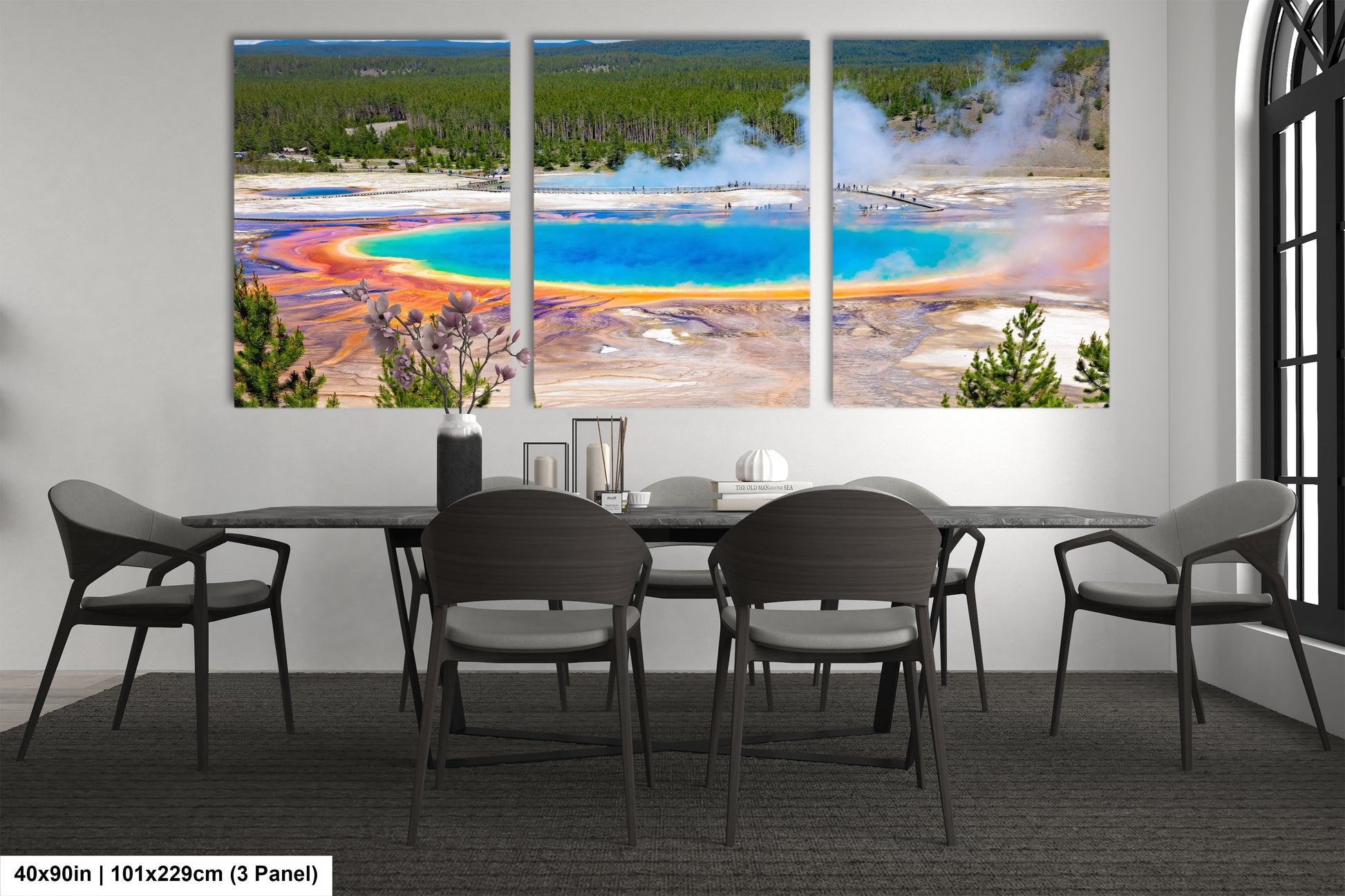 a dining room table with four chairs and a painting on the wall