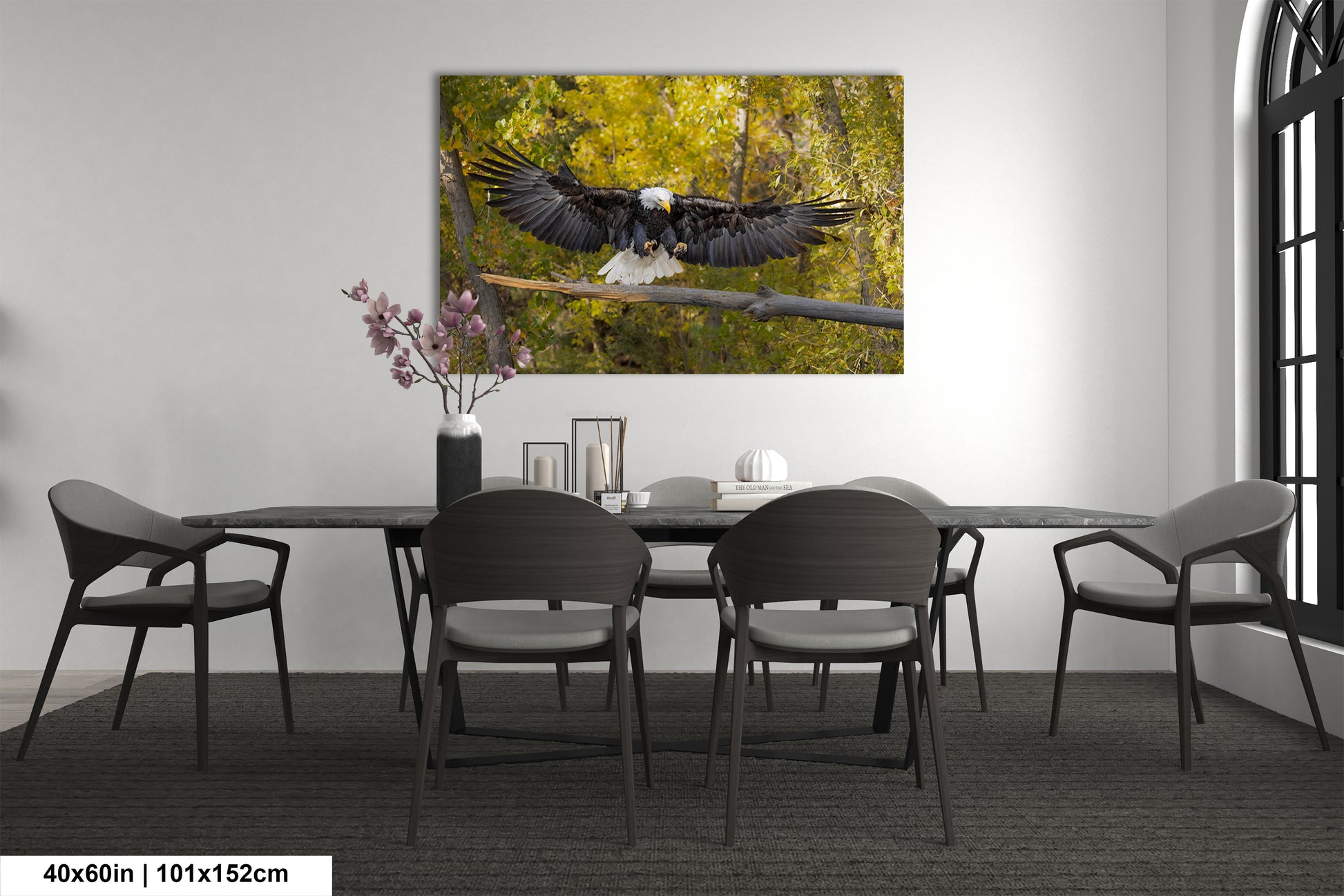 a table with chairs and a painting of an eagle on the wall