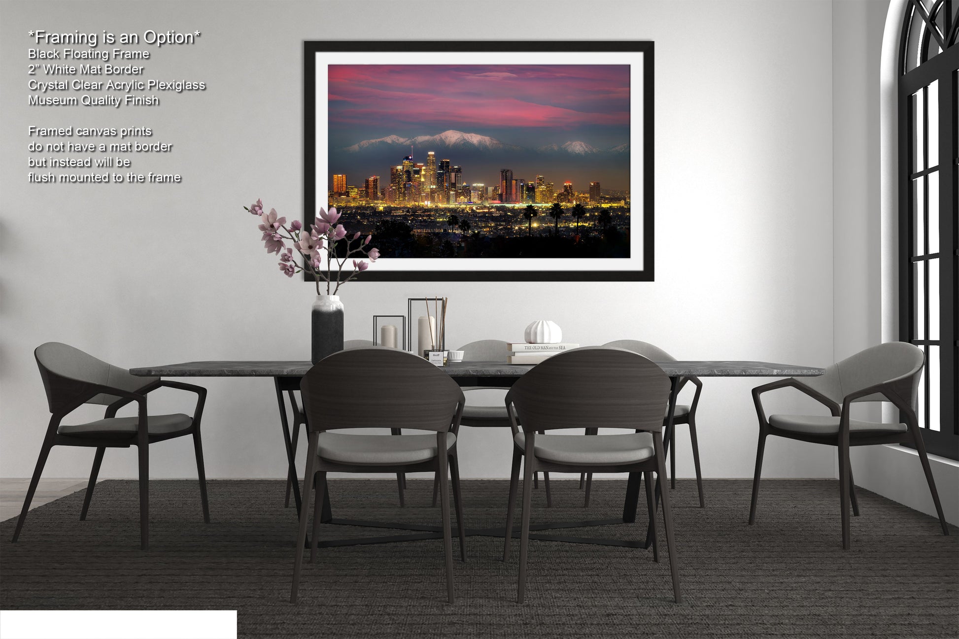 a dining room table with chairs and a picture hanging above it