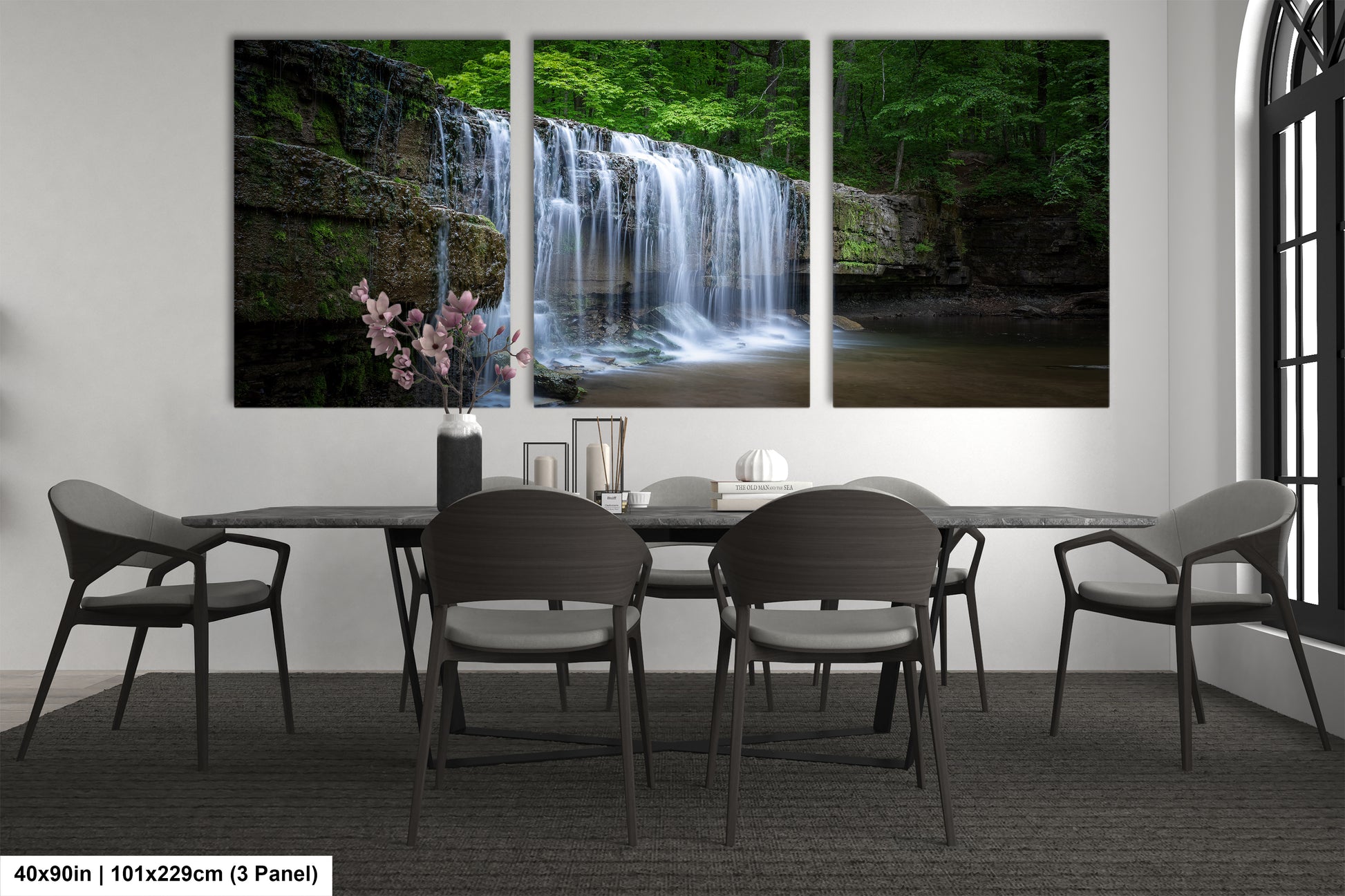 a dining room table with four chairs and a waterfall in the background
