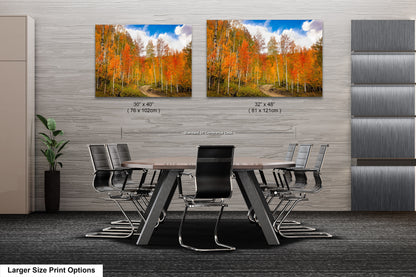 a dining room table with chairs and two pictures on the wall