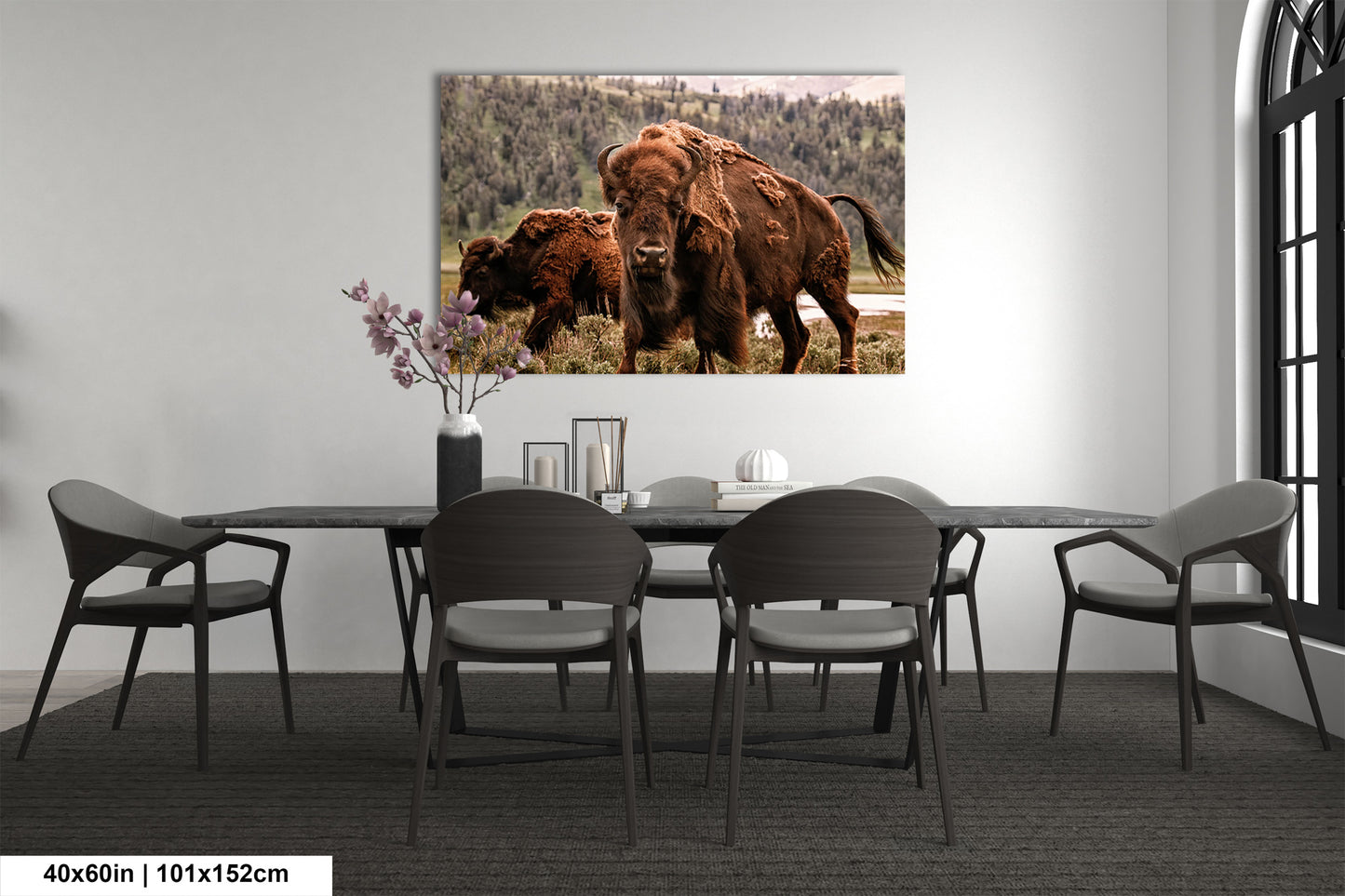 a dining room table with chairs and a picture of a bison on the wall