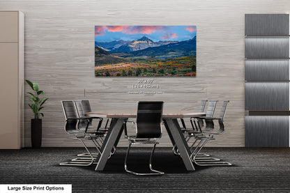 a dining room table with a view of a mountain range