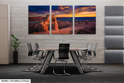 a dining room table with chairs and a painting on the wall