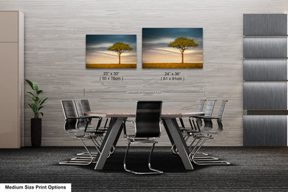 a dining room table with chairs and a picture of a tree on the wall