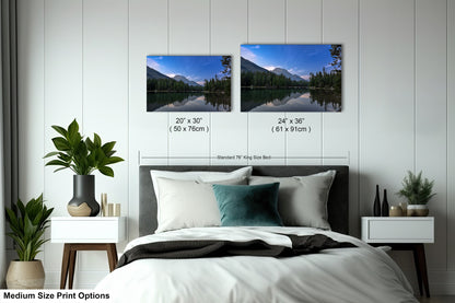 a bedroom with a bed and two pictures on the wall