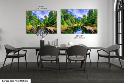 a dining room table with four chairs and two pictures on the wall