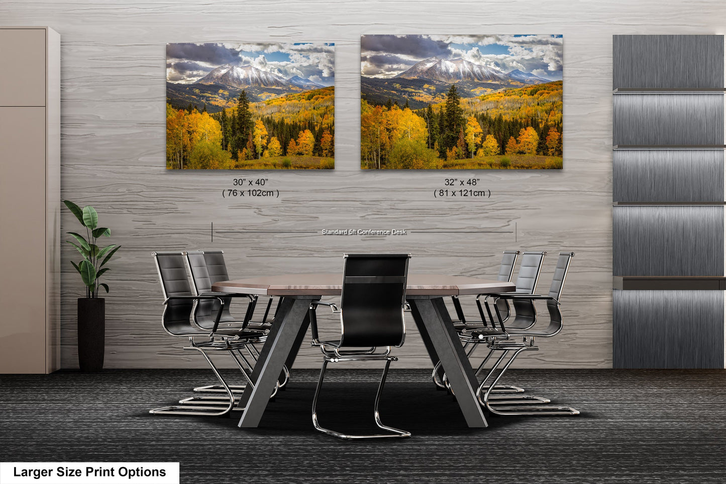a dining room table with chairs in front of two pictures of mountains