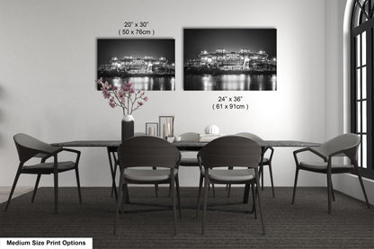 a dining table with four chairs and a vase of flowers